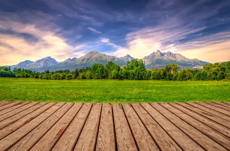 Wooden planks floor with summer mountain landscape. Beautiful view on High Tatra Mountains, Slovakia.の写真素材