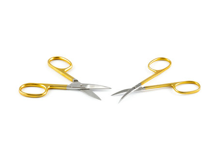 Gold silver metal nail scissors. Small metal manicure scissors isolated on white background.の写真素材