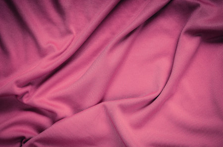Pink wrinkled fabric texture. Close-up of soft cotton cloth, may be used as background.の写真素材