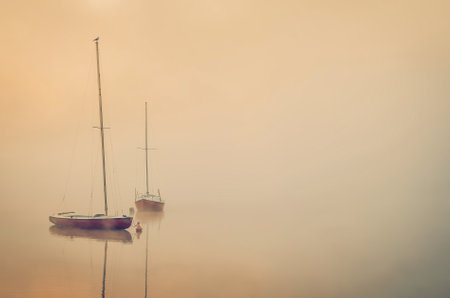 Foggy morning on the lake. Boats at Lake Parpocany in Tychy, Poland.の写真素材