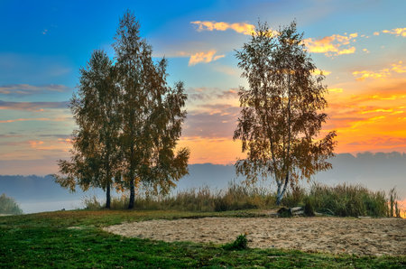 Foggy colorful morning on the lake. Sunrise over Lake Paproacany in Tychy, Poland.の写真素材