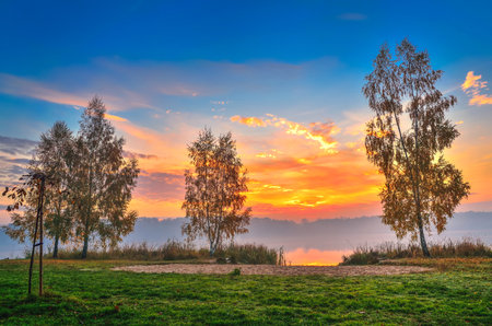 Foggy colorful morning on the lake. Sunrise over Lake Paproacany in Tychy, Poland.の写真素材