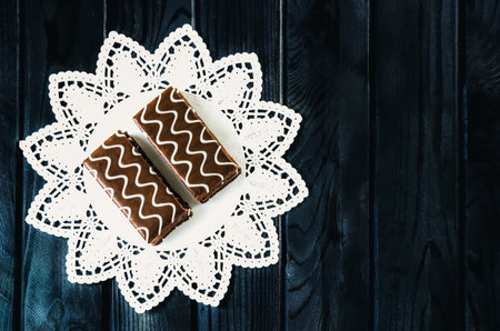 Table setting with cookies with chocolate. Chocolate coated biscuits on a white napkin.の写真素材