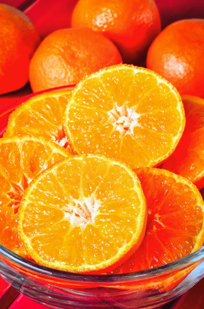 Concept with orange fresh fruits. Tangerines in a glass bowl.の写真素材