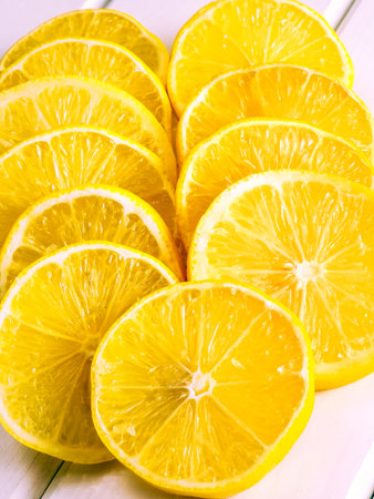 Concept with fresh yellow fruits. Slices of lemon on the white boards.の写真素材