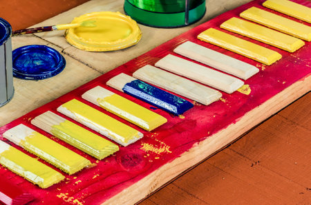 Brushes , paint and wooden boards . Painting the boards with colored paints.の写真素材