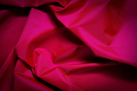 Pink wrinkled fabric texture. Close-up of textile structure, may be used as background.の写真素材
