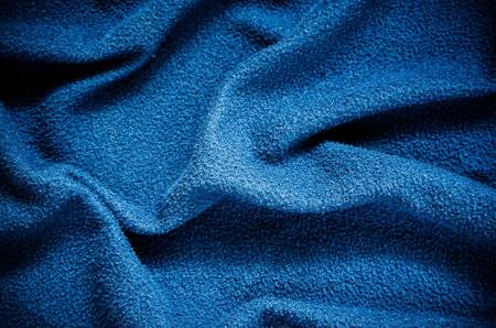 Blue wrinkled fabric texture. Close-up of soft cotton cloth, may be used as background.の写真素材