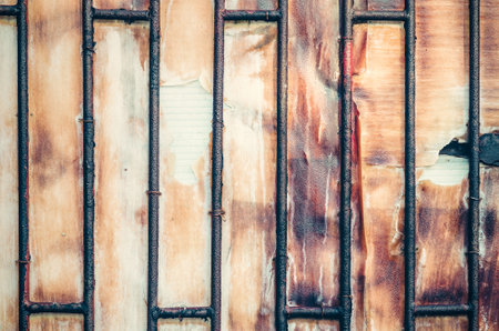 Old metal wooden door. Background of metal door with wood inside.の写真素材