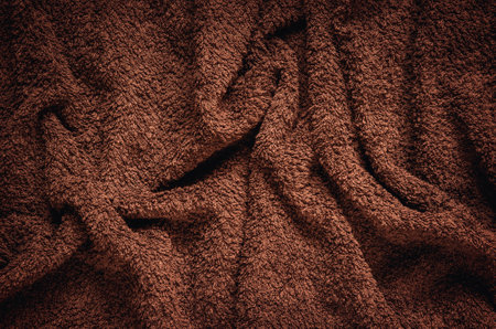 Furry wrinkled blanket texture. Close-up of brown material, may be used as background.の写真素材