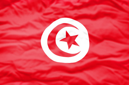 Tunisia flag on a wavy background. Wavy flag of Tunisia fills the frame.の写真素材