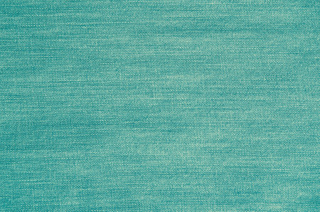 Background of denim material. The texture of blue jeans trousers.の写真素材