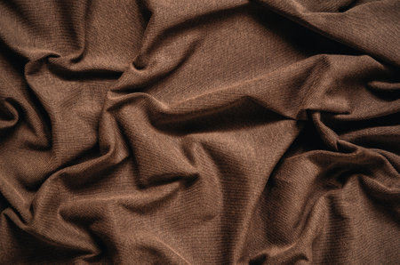 Brown wrinkled fabric texture. Close-up of soft cotton cloth, may be used as background.の写真素材