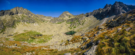 Summer mountain landscape in a panoramic perspective. View of a beautiful mountain valley in High Tatra, Slovakia.の写真素材
