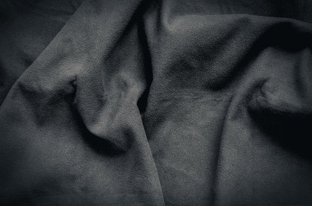 Black wrinkled fabric texture. Close-up of soft cotton cloth, may be used as background.の写真素材