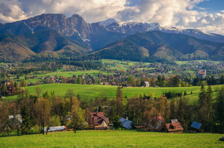 Beautiful country view with mountains in the background. View of the Tatra Mountains and Koscielisko Village in Poland.の写真素材
