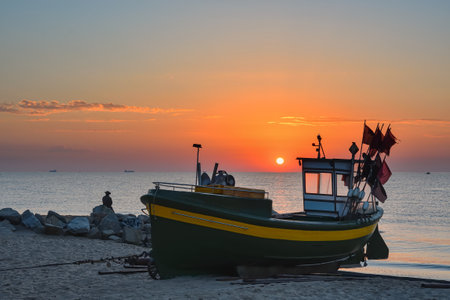 Beautiful morning view at the Polish seaside in Gdynia. Ship on a sandy beach in the morning. Photo taken in Gdynia Orlowo on the Baltic Sea in Poland.の写真素材