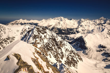 Mountain panorama in winter scenery. Beautiful white snow capped peaks in the Polish Tatra Mountains.の写真素材