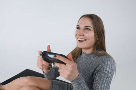 Cheeful involved girl playing video gamesの写真素材