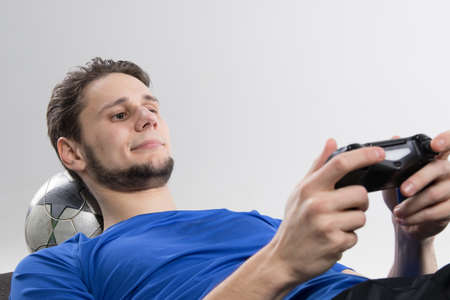 Young man playing video games in black shirt isolated