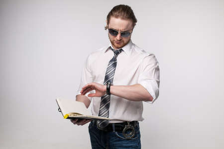 Portrait of young redhead man with beard white shirt and grey tie sunglasses isolatedの写真素材