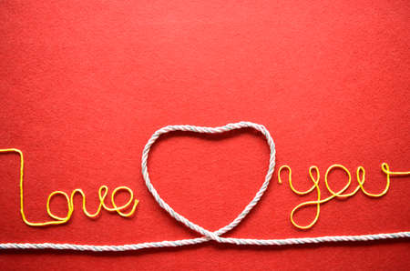 Valentines day card - heart made from wire on red backgroundの写真素材