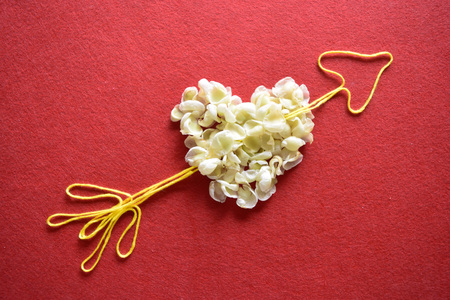 Valentines day card - heart made of ribbon on red background