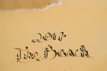 2017 written in sand, on tropical beachの写真素材