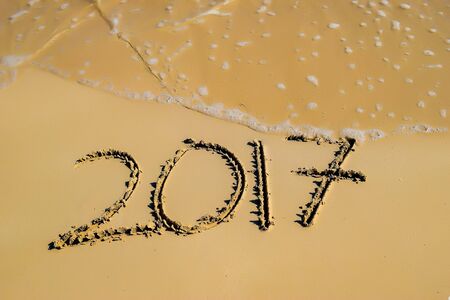 2017 written in sand, on tropical beachの写真素材