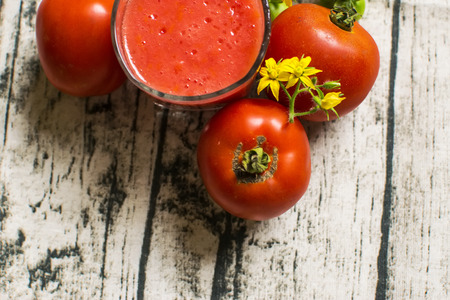 Tomato smoothie - tomato juice on wood backgroundの写真素材