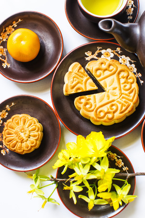 Mooncake and tea, food and drink for Chinese mid autumn festival. Isolated on white backgroundの写真素材