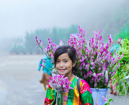 DONG VAN, HA GIANG, VIETNAM, October 13th, 2018: Unidentified ethnic minority kids with baskets of rapeseed flower in Hagiang, Vietnam. Hagiang is a northernmost province in Vietnamのeditorial素材