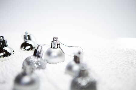 Christmas card, illustration with golden baubles, balls, decorations, ornaments on a silver white background with blurry, blurred, lights (bokeh), soft, neutral, warm colors and Merry Christmas textの写真素材