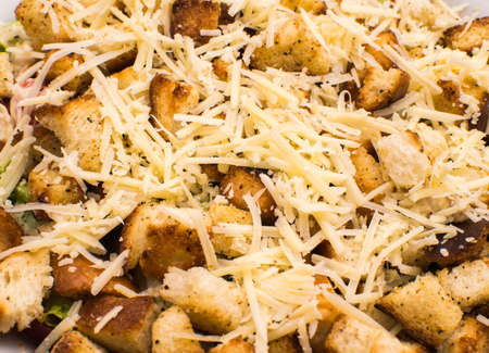 Salad: croutons with the garlic, grated cheese, slices of chicken, lettuce leavesの写真素材