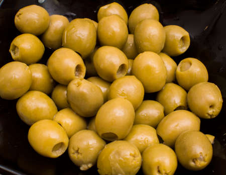 Marinaded olives in a black square plateの写真素材
