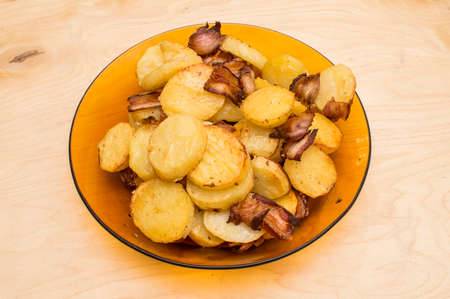 The young potatoes baked with bacon with spicesの写真素材