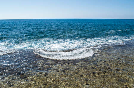 Small surf at the silent blue seaの写真素材
