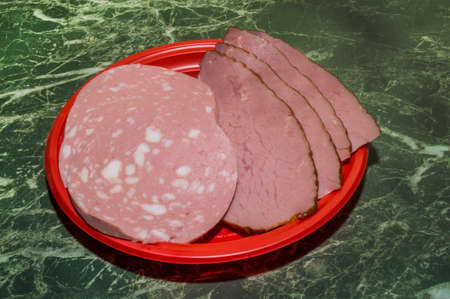 The meat and boiled sausage cut with slices