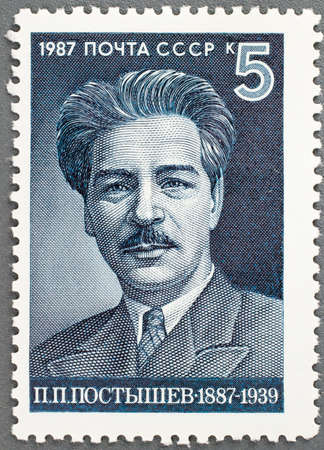 USSR - CIRCA 1987: A post stamp printed in USSR shows portrait P. Postyshev's, circa 1987のeditorial素材