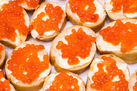 Sandwiches: red caviar, yellow butter, white loafの写真素材