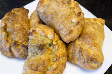 Pies from puff pastry on a white dish