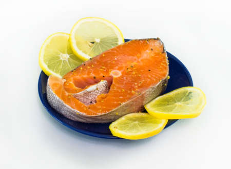 The Norwegian trout with lemons on a blue dishの写真素材