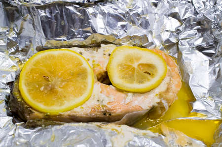 Norwegian trout baked with lemons on a foilの写真素材