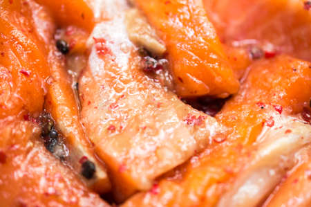 Slices of a salty trout under pink pepper