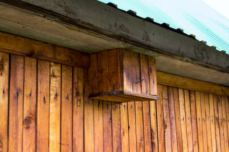 The roof from a metal tile and a wooden wall