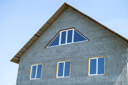 The house from foam concrete blocks with a roof and windowsの写真素材
