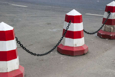 The concrete painted restrictive columns and a chainの写真素材