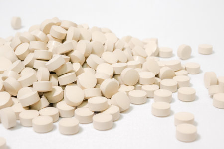 Pills scattered on white background