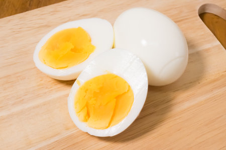 Boiled Egg Cut in Half on Cutting Board