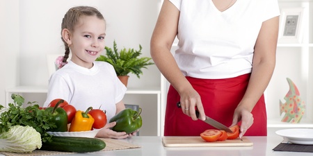 mom and daughter cooking togetherの写真素材
